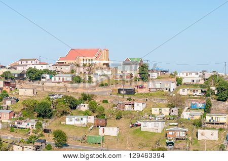 KNYSNA SOUTH AFRICA - MARCH 5 2016: A view of Queen of the Holy Rosary Catholic Church and houses and shacks in Khayalethu Township in Knysna