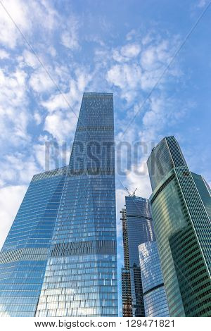Several buildings of Moscow City under blue sky with clouds. Moscow Russia. May 02 2016.