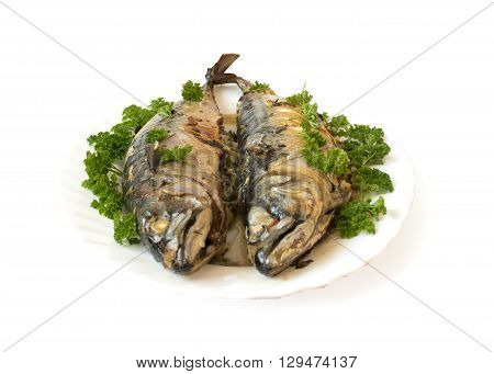Mackerel stuffed with herbs on a white background