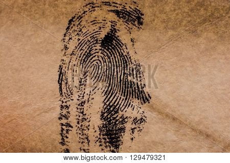 Fingerprint on a brown  old styled paper
