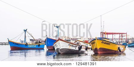 Paracas - Peru October 15 2014: View of a group of anchored fisher boats in a cloudy morning in Paracas Peru