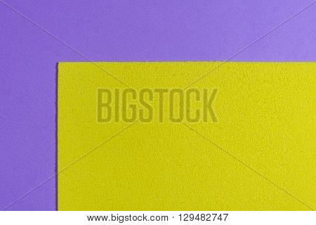 Eva foam ethylene vinyl acetate sponge plush lemon yellow surface on light purple smooth background