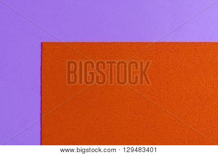 Eva foam ethylene vinyl acetate sponge plush orange surface on light purple smooth background