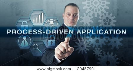 Developer pushing PROCESS-DRIVEN APPLICATION on a touch screen display. Process management metaphor and business concept for enterprise solution software application relating to humans and systems.