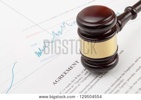 Wooden Judge's Gavel And Calculator Over Some Financial Documents