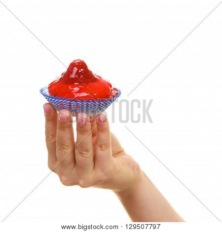 Sweet food indulging and fattening concept. Delicious tasty sweet cake cupcake in human hand isolated on white