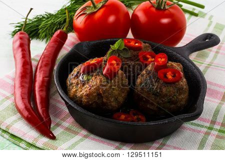 Meatballs served in a cast iron skillet. Turkish meatball. Meatloaf. Grilled meatballs. Meatballs.