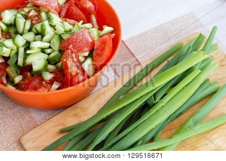Fresh healthy salad on wooden table. Top view.the salad on the tablegreen onion