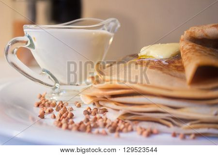 Pile of buckwheat pancakes with cream old fashion style