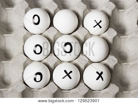 WIN. Drawing on white eggs - tic-tac-toe game