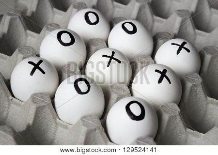 WIN. Drawing white  on eggs - tic-tac-toe game