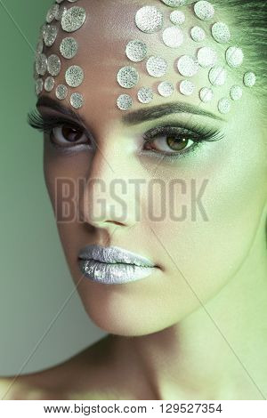 Make up and beauty. Woman with rhinesones on face. Artistic on stage make up