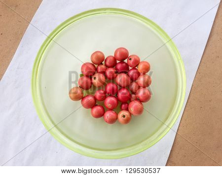 close up fresh red Jamaican cherry fruit on white paper