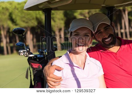couple in buggy cart on golf course