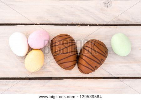 Easter Candy Eggs On A Wooden Table