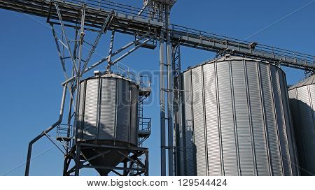 Steel Grain Silos Agaist the Blue Sky.