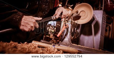 Woodturners Using A Rotating Clamp To Turn The Wood.