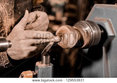 Woodturners Using A Rotating Clamp To Turn The Wood.