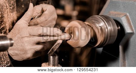Woodturners Using A Rotating Clamp To Turn The Wood.