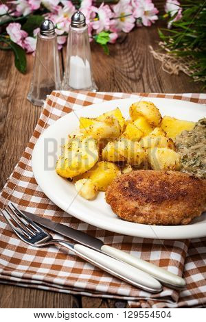 Delicious Meal Of Minced Meat Cutlet, Potatoes And Fried Cabbage.