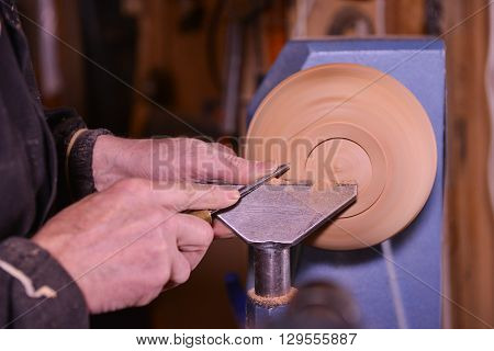 Woodturners Using A Rotating Clamp To Turn The Wood.