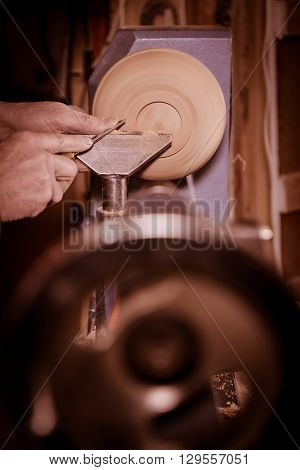 Woodturners Using A Rotating Clamp To Turn The Wood.