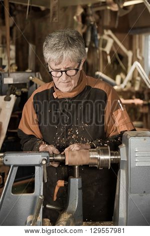 Woodturners Using A Rotating Clamp To Turn The Wood.