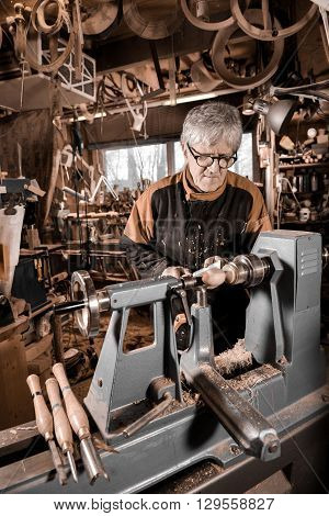 Woodturners Using A Rotating Clamp To Turn The Wood.