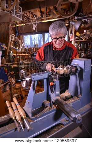 Woodturners Using A Rotating Clamp To Turn The Wood.
