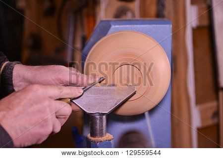 Woodturners Using A Rotating Clamp To Turn The Wood.