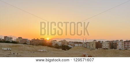 city on the edge of the desert during the evening twilight