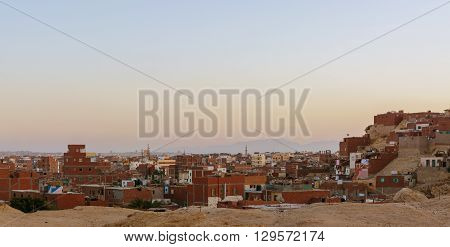 city on the edge of the desert during the evening twilight