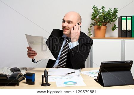 Manager presents the sales figures. He is smiling