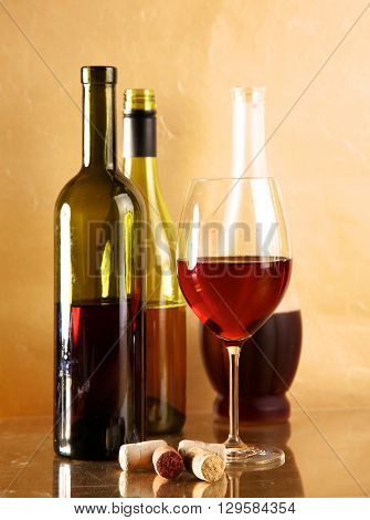 wine bottle and wine glass on a glass table.