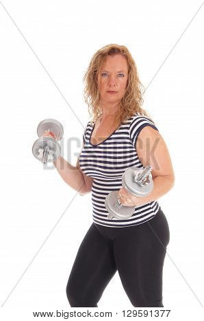 A strong middle age woman in black pants and striped top working out with dumbbells isolated for white background.