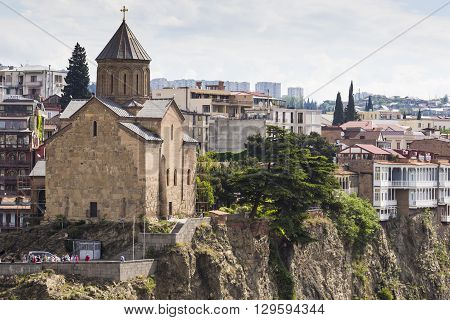 TBILISI GEORGIA - MAY 07 2016: Metekhi Church above the Kura river in Tbilisi Georgia.