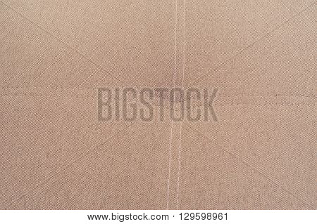 Brown natural stitched fabric texture for the background. Space for text