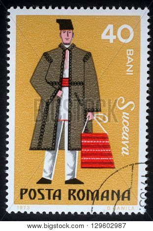 ZAGREB, CROATIA - JULY 18: A stamp printed in the Romania, shows the traditional dress of men in the region Suceava, circa 1973, on July 18, 2012, Zagreb, Croatia