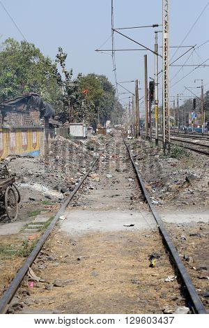 TITAGARH, INDIA - FEBRUARY 09: Trains passing through the slums where people live in difficult conditions on February 09, 2014 in Titagarh, West Bengal, India.