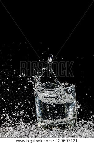 water splash in glass on black background