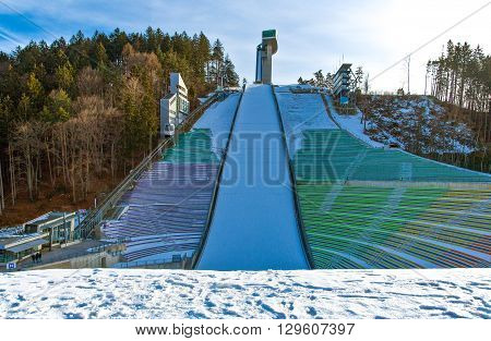 Innsbruck Austria - February 8 2010: The snowy Bergisel skijamping stadium at sunset