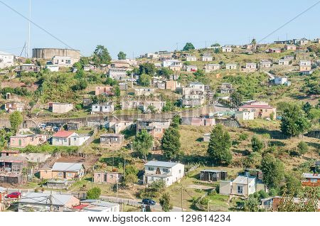 KNYSNA SOUTH AFRICA - MARCH 5 2016: A view of a reservoir and houses on a hill in the Khayalethu township in Knysna