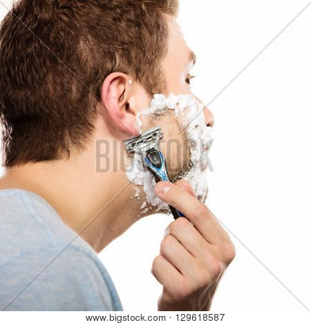 Health beauty and skin care concept. Closeup young bearded man with foam on face shaving on white background.