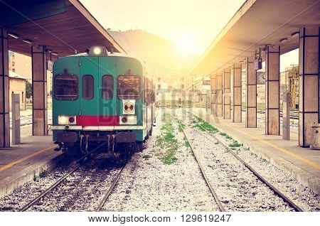 Arrival of the local train to Trapani railway station at sunset. Sicily. Italy.