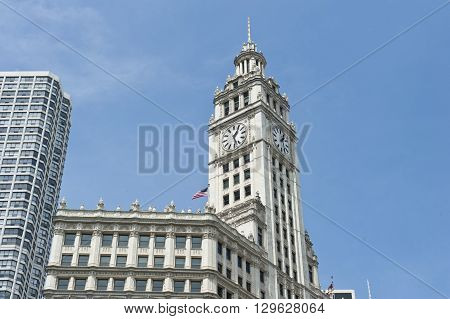 View of the skyscraper and clock tower of Wrigley building in Chicago, Illinois. Wrigley building is a tall skyscraper on Magnificent Mile and headquarters to Wrigley Company.