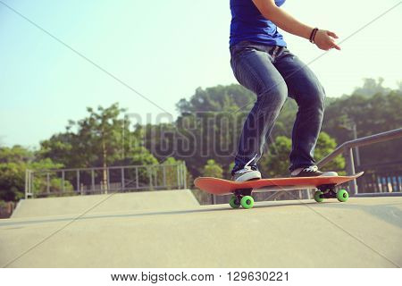 young skateboarder skateboarding at outdoor skate park