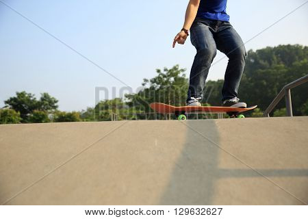 young skateboarder skateboarding at outdoor skate park