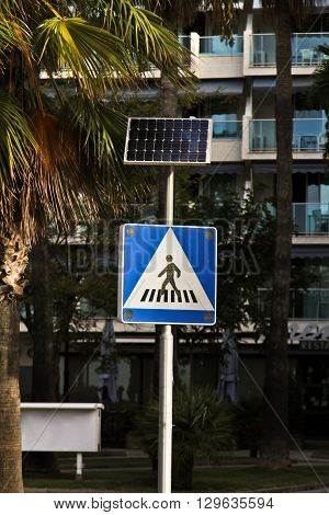 Crosswalk with solenchnoy battery on street in Spain