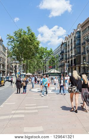 BARCELONA SPAIN-MAY 13 2016: Barcelona is the capital of the autonomous community of Catalonia in Spain city. Crowd of people visit the Rambla de Barcelona Spain.