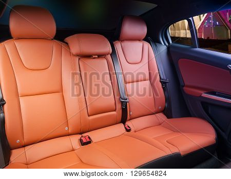 Car interior, back seats with night city in the windows
